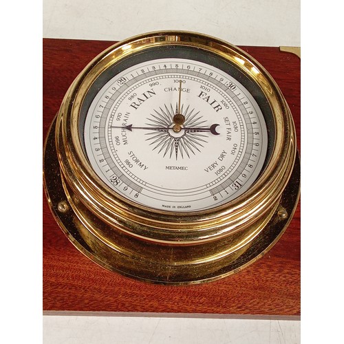 304 - Brass finish wall clock and barometer set in a wooden display backing. Metamec Quarts. Used conditio... 