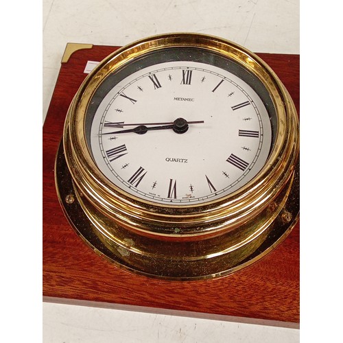 304 - Brass finish wall clock and barometer set in a wooden display backing. Metamec Quarts. Used conditio... 