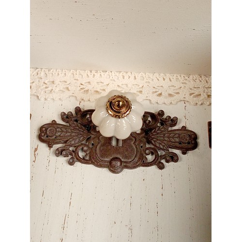 306 - A wooden key rack designed with the 'distressed look'. Metal fittings and decoration in good overall... 