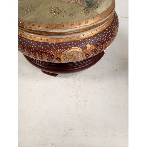 305 - Japanese oriental design lidded pot on dark wood stand. Stamped with an Eastern stamp underneath, th... 