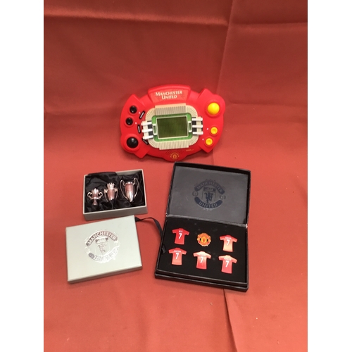 35 - Manchester United memorabilia inc Tiger handheld game, miniature trophy & pin badges