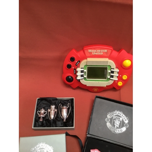 35 - Manchester United memorabilia inc Tiger handheld game, miniature trophy & pin badges