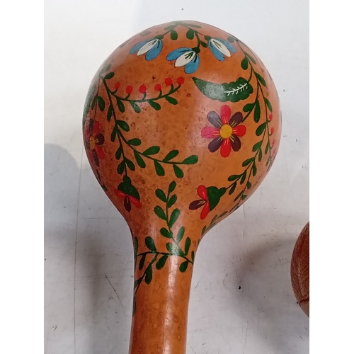 254 - 3 maracas. One pair smaller than a single large one. Look hand painted with great detail