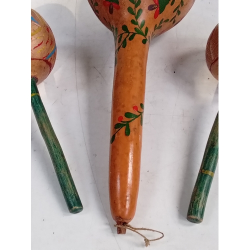 254 - 3 maracas. One pair smaller than a single large one. Look hand painted with great detail