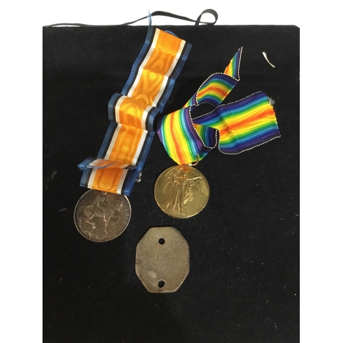 68 - Defence and victory WWII medals with original dog tag also - issued to 175038 GNR F J Hudson