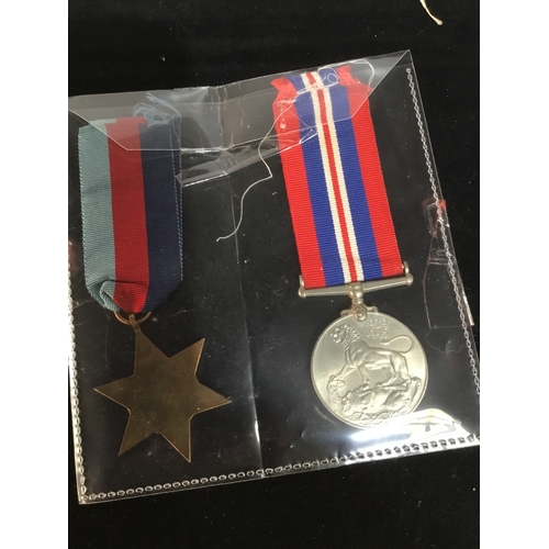 69 - WWII defence medal & 1939-45 bronze star with ribbon - un-named as issued