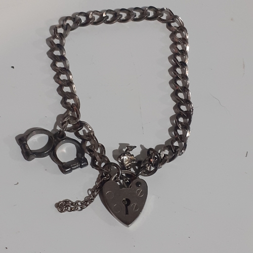 53B - Sterling silver padlock charm bracelet with 2 charms. Clasp works fine. Wood benefit a clean.  Weigh... 