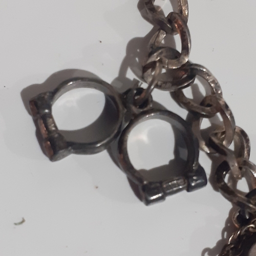 53B - Sterling silver padlock charm bracelet with 2 charms. Clasp works fine. Wood benefit a clean.  Weigh... 