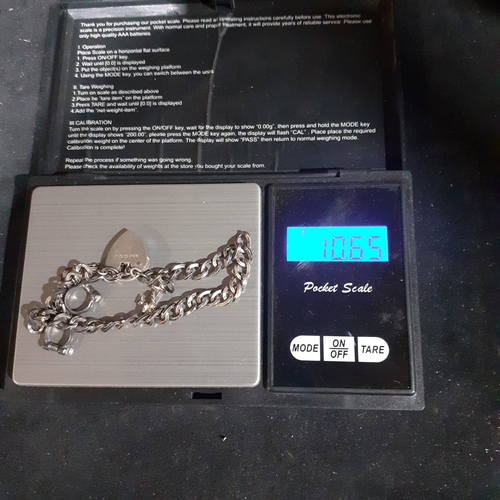 53B - Sterling silver padlock charm bracelet with 2 charms. Clasp works fine. Wood benefit a clean.  Weigh... 