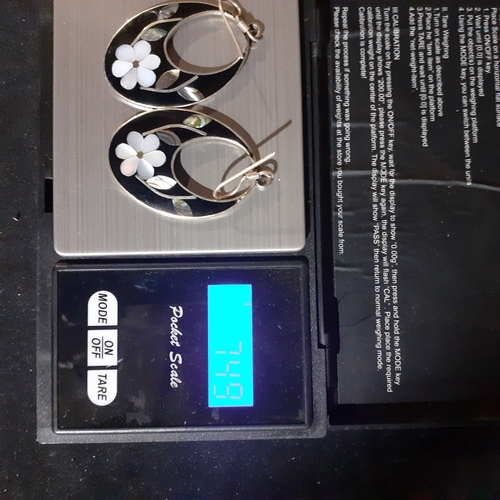 54B - Pair of Mexican silver oval shaped earrings with mother of pearl effect flower design. Very eye-catc... 