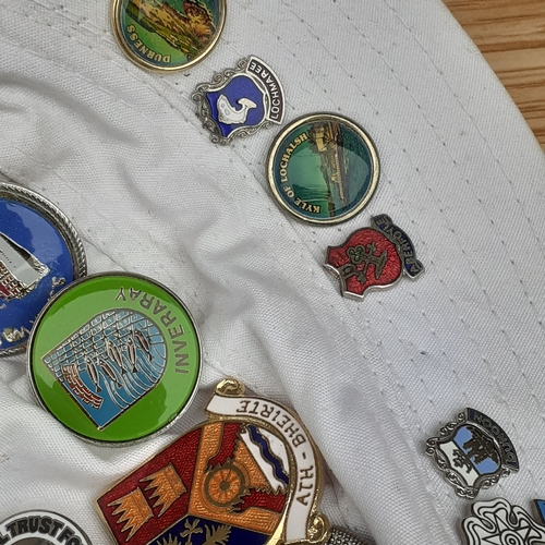 16 - 2 hats with one and a bit covered in various collections pin badges. Lots travel related in overall ... 