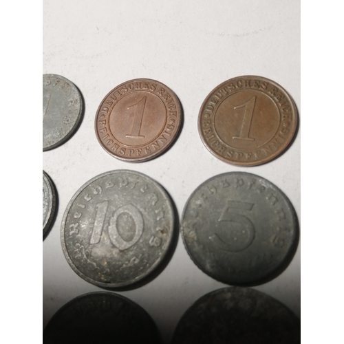 21A - COINS : GERMANY 9 WWl and WWII coins Many with swastika on the reverse