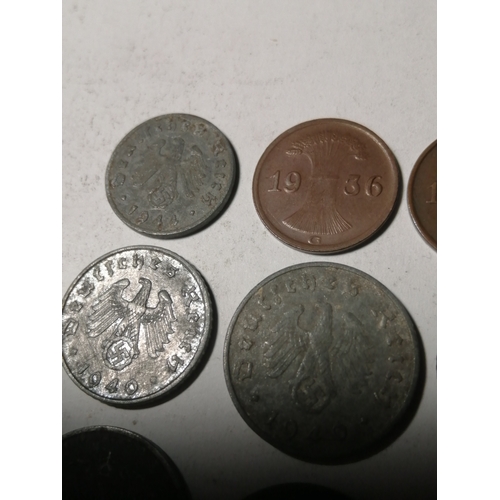 21A - COINS : GERMANY 9 WWl and WWII coins Many with swastika on the reverse