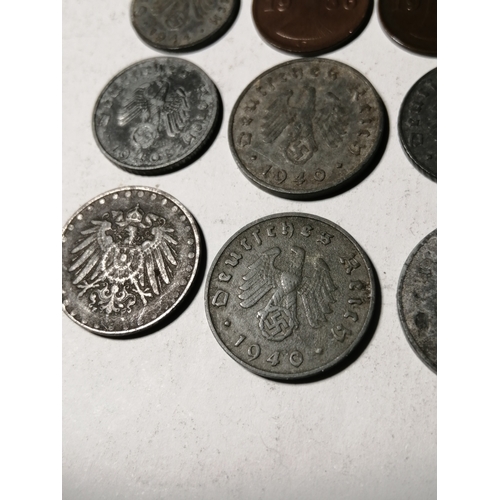 21A - COINS : GERMANY 9 WWl and WWII coins Many with swastika on the reverse