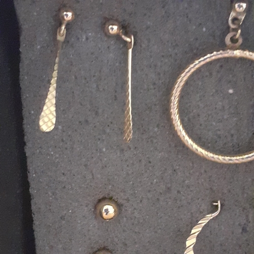 5 - Several pairs of gold coloured metal earrings. Mostly drop hoops with one pair of studs. Nice condit... 