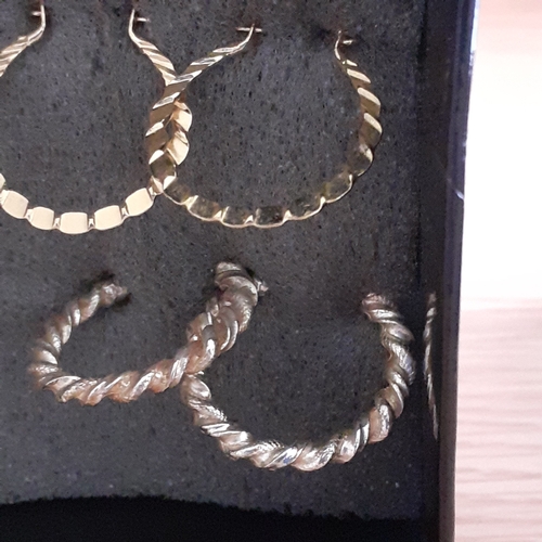 5 - Several pairs of gold coloured metal earrings. Mostly drop hoops with one pair of studs. Nice condit... 