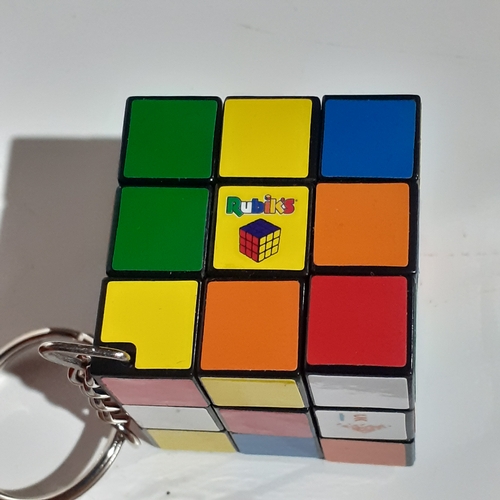 4 - 2 genuine Rubiks cubes, a keyring Rubiks and a solution/instruction book. Very nice clean condition.