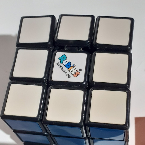 4 - 2 genuine Rubiks cubes, a keyring Rubiks and a solution/instruction book. Very nice clean condition.