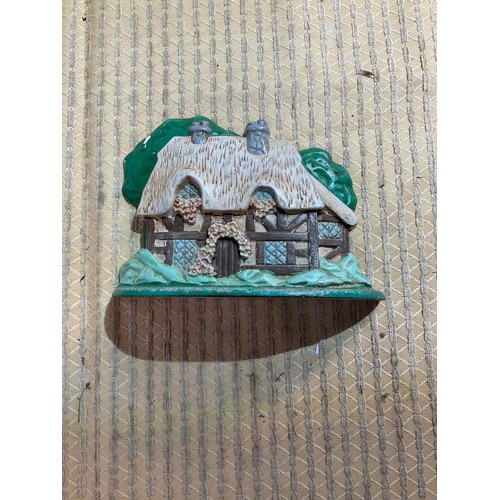 35 - Cast iron cottage themed door stop