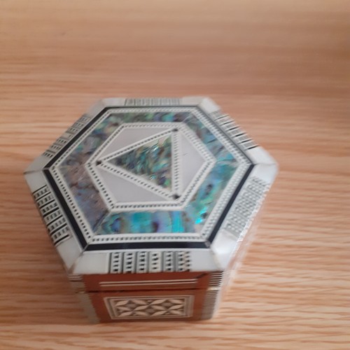 2 - An eye-catching wooden trinket box containing a number of religious related jewellery items includin... 