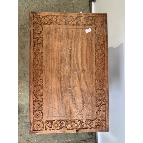 225 - Small ornately carved wooden side coffee table