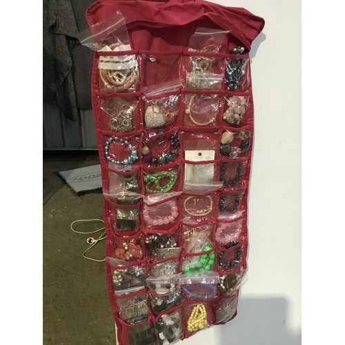 139 - Large door hanging storage pouch full of costume jewellery - double sided - most as new