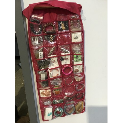 139 - Large door hanging storage pouch full of costume jewellery - double sided - most as new