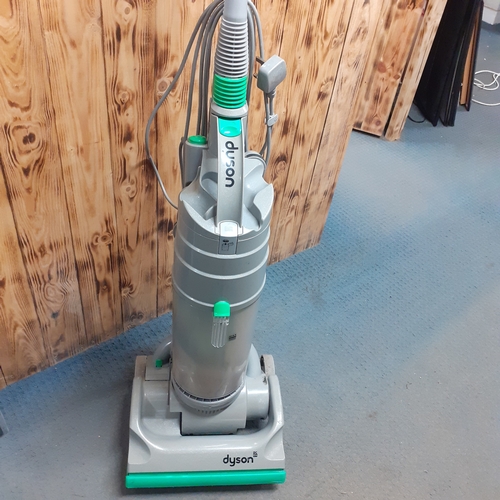 24 - Dyson DC04 vacuum. Silver with green trim. Overall pretty clean, good condition and fully working