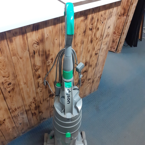 24 - Dyson DC04 vacuum. Silver with green trim. Overall pretty clean, good condition and fully working