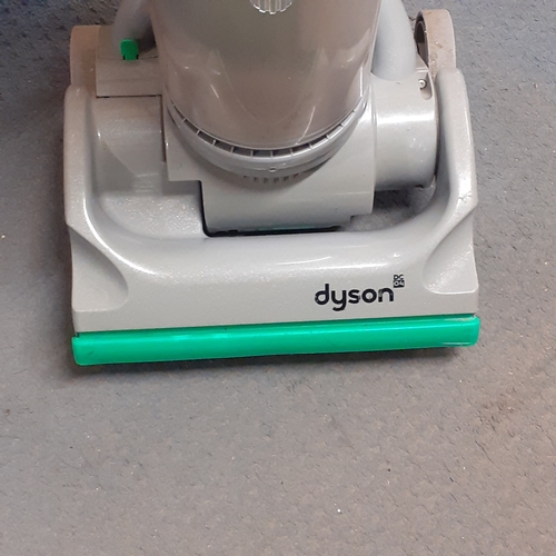 24 - Dyson DC04 vacuum. Silver with green trim. Overall pretty clean, good condition and fully working