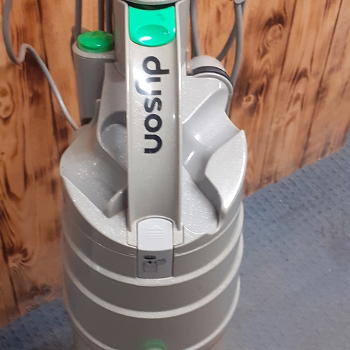 24 - Dyson DC04 vacuum. Silver with green trim. Overall pretty clean, good condition and fully working