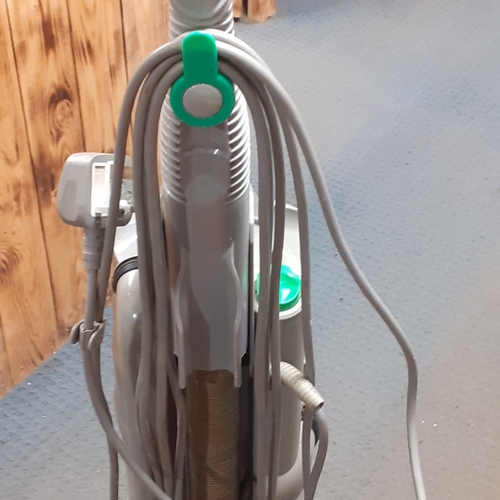 24 - Dyson DC04 vacuum. Silver with green trim. Overall pretty clean, good condition and fully working