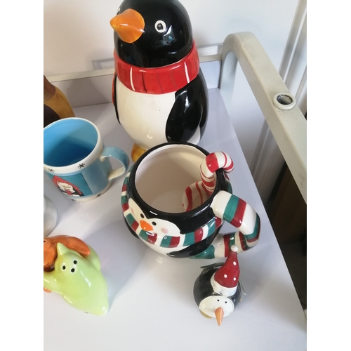 60A - Large collection of penguin related items including biscuit barrel, mugs and condiment set