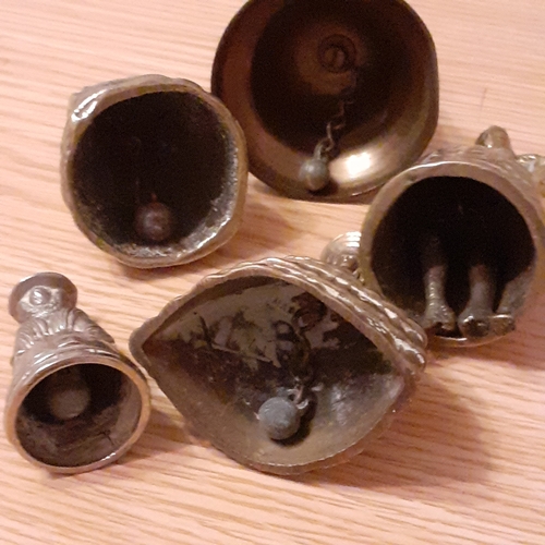 118A - A collection of Brass Bells with a Ship and some Dutch Figures. Approx 827g combined weight and all ... 