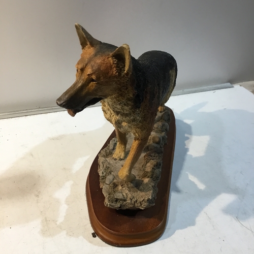 205 - Caithness Scotland natural world dog figure on wooden plinth