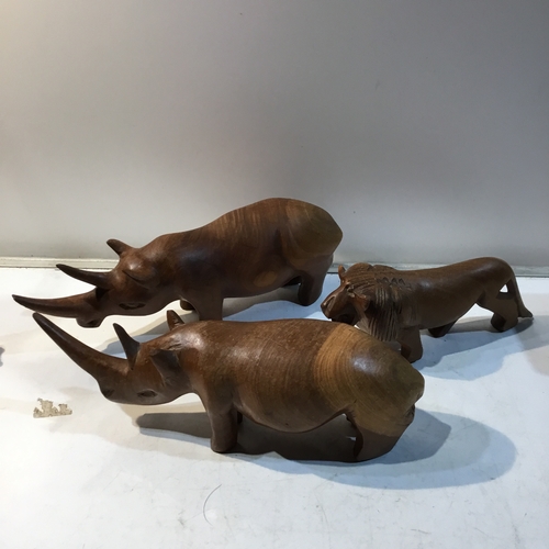 216 - Pair of wooden rhino’s and a wooden tiger ornament