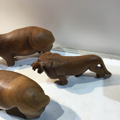 216 - Pair of wooden rhino’s and a wooden tiger ornament