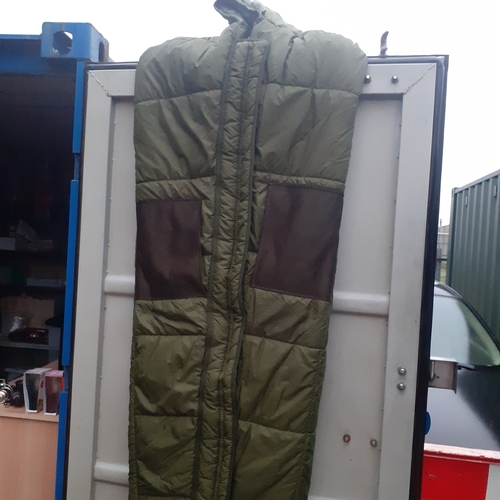 423 - Good quality green military/fishing sleeping bag. Quilted, netting pockets and a hood. Has ties for ... 