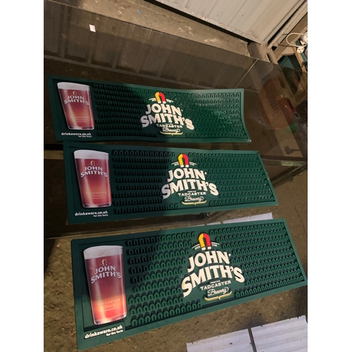 966 - Trio of John Smiths silicone beer mats