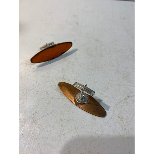 239 - Pair of copper shirt cufflinks with orange enamel feature