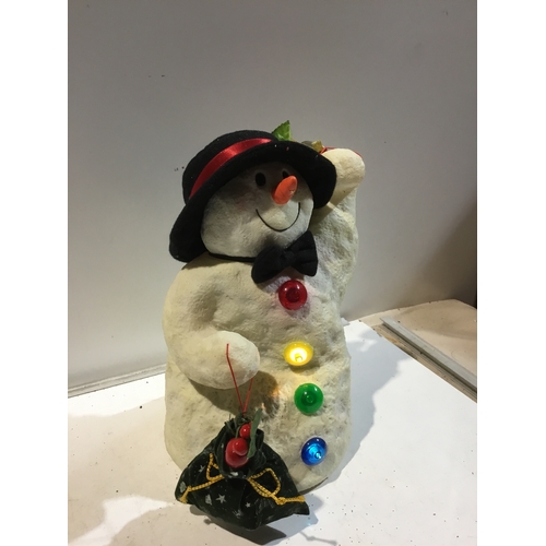 146 - Battery operated snowman sings lights & wobbles working