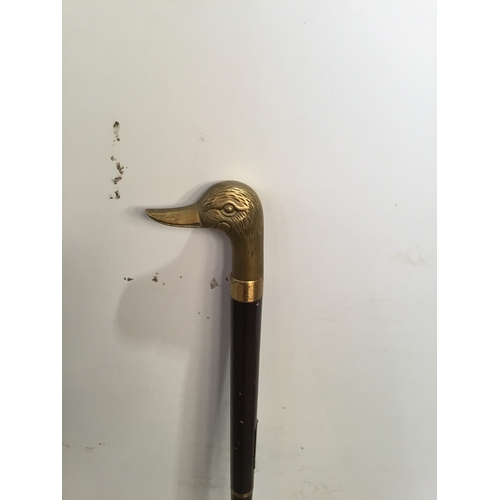 84 - Brass duck head walking stick with black cane