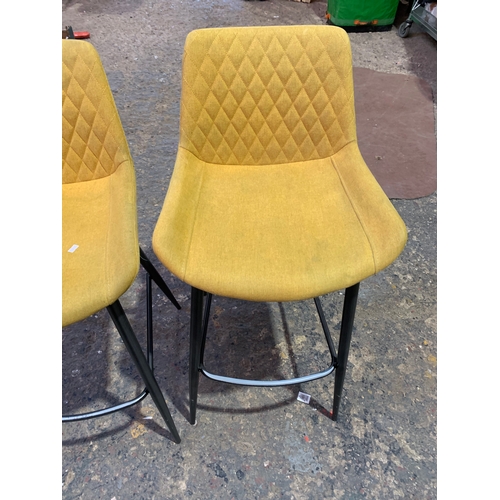 189 - Pair of yellow modern upholstered bar stools