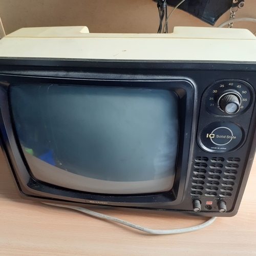 13 - Black and white Sharp TV. Good condition with no damage. Powers up