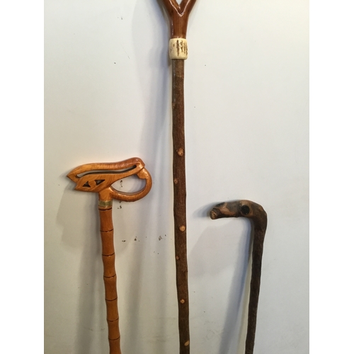 265 - Trio of ornately carved design walking sticks