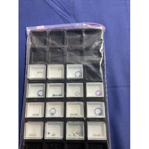 114 - Tray of individually boxed, body piercing jewellery