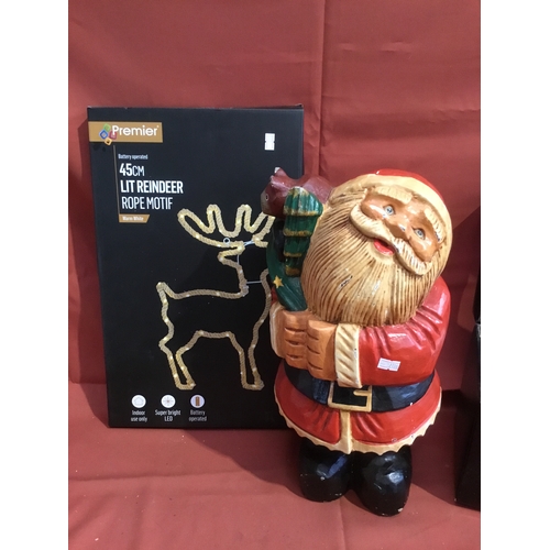 134 - Wooden carved Santa figure approx size 16.5 inches and a battery operated 45cm lit reindeer rope mot... 