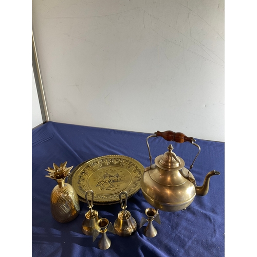 83 - Mixed lot of brass items including a 3 footed teapot, candle holders, 2 bells, decorative plates and... 