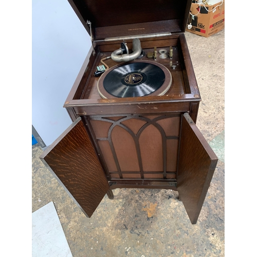 301 - His Masters Voice gramophone in oak case with cartridge and handle