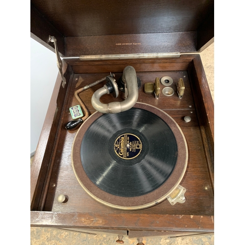 301 - His Masters Voice gramophone in oak case with cartridge and handle